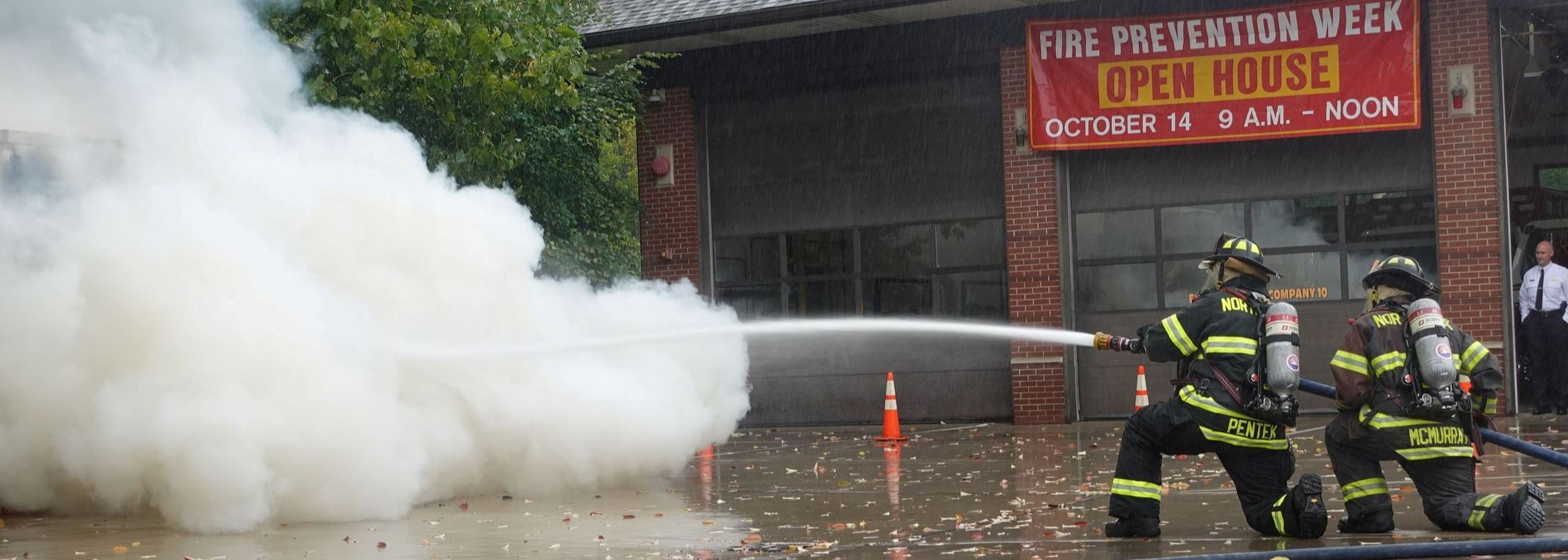 Firefighter putting out a fire at an Open House Demo
